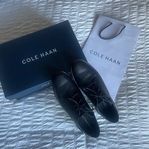 Black Cole Haan leather lace-up oxfords
